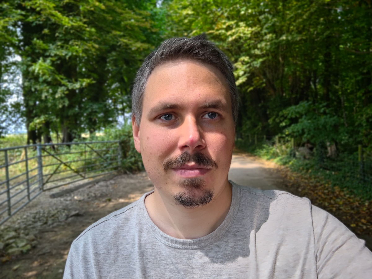 Asus Zenfone 9 camera sample selfie portrait HDR of a man with facial hair wearing a light colored tshirt