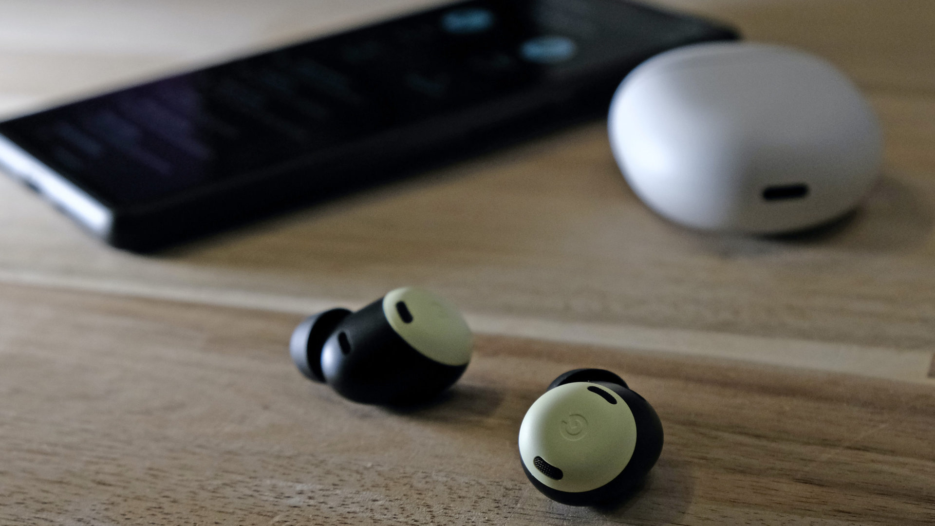 Google Pixel Buds Pro headphones on a table phone