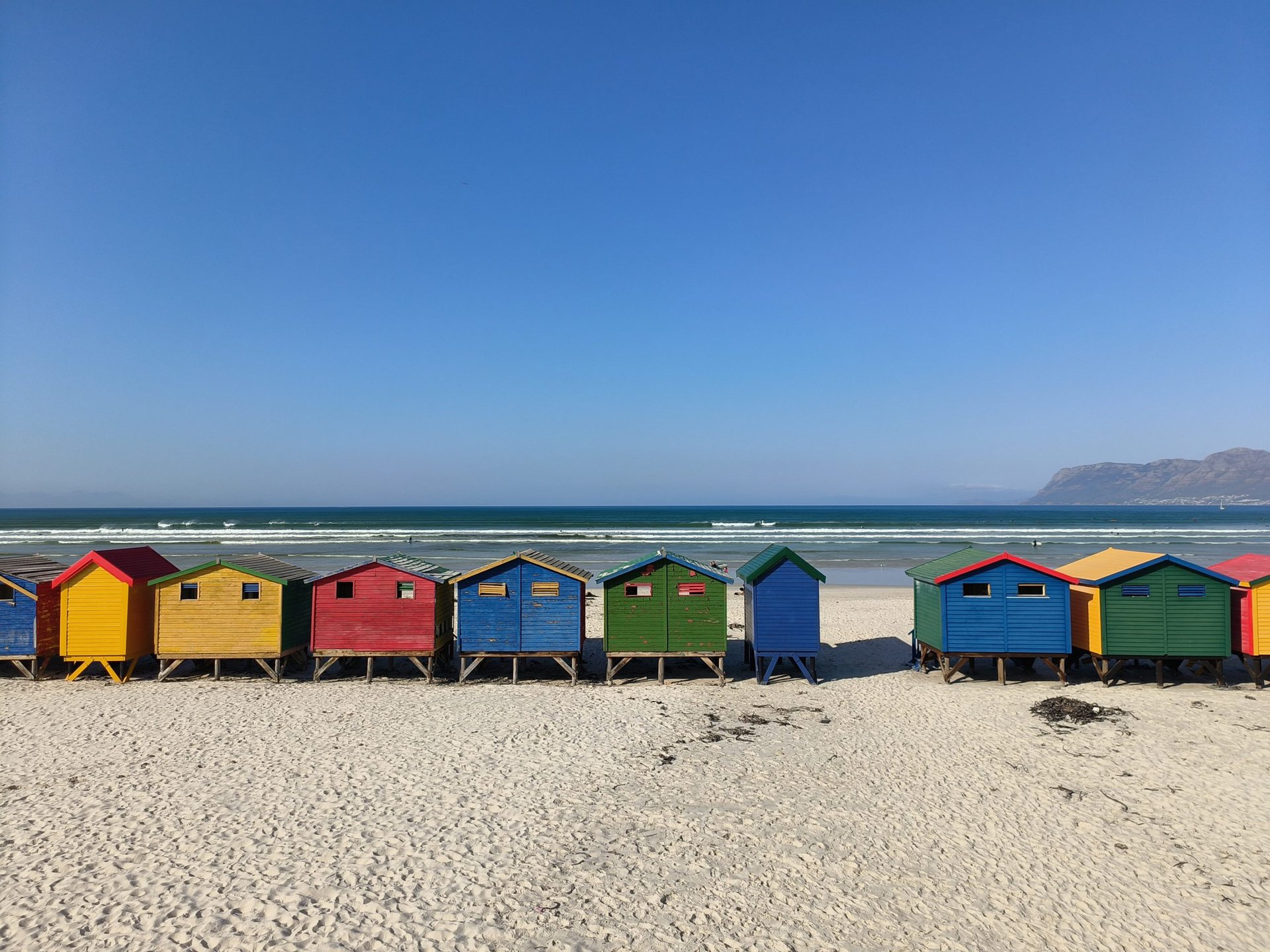 Oppo Reno 8 Pro 1x shot of colorful beach huts on a sandy beach.