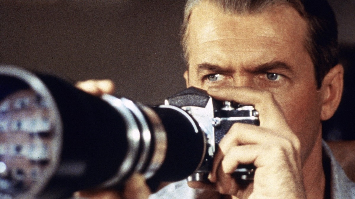 James Stewart holding a camera to his face in Rear Window