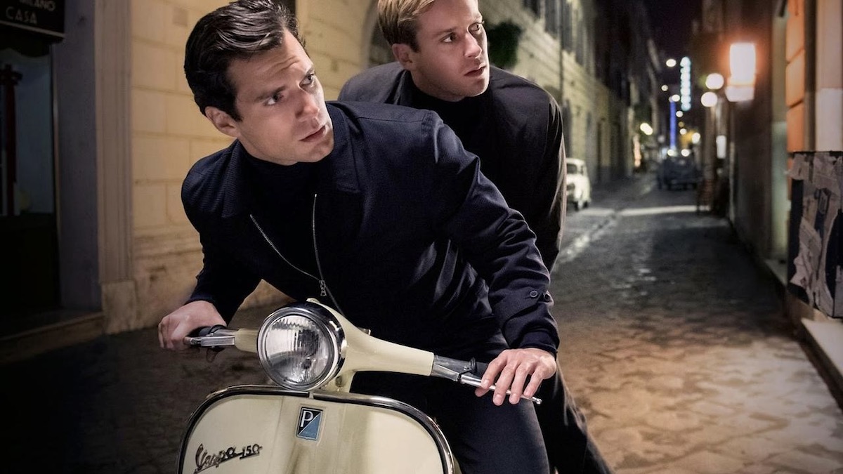 Henry Cavill and Armie Hammer on a motorbike in The Man from UNCLE - movies like The Gray Man