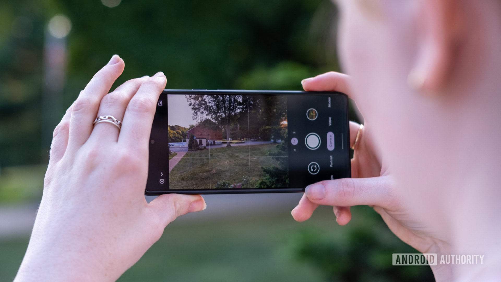 A woman takes a shot using the google pixel 6a camera in landscape