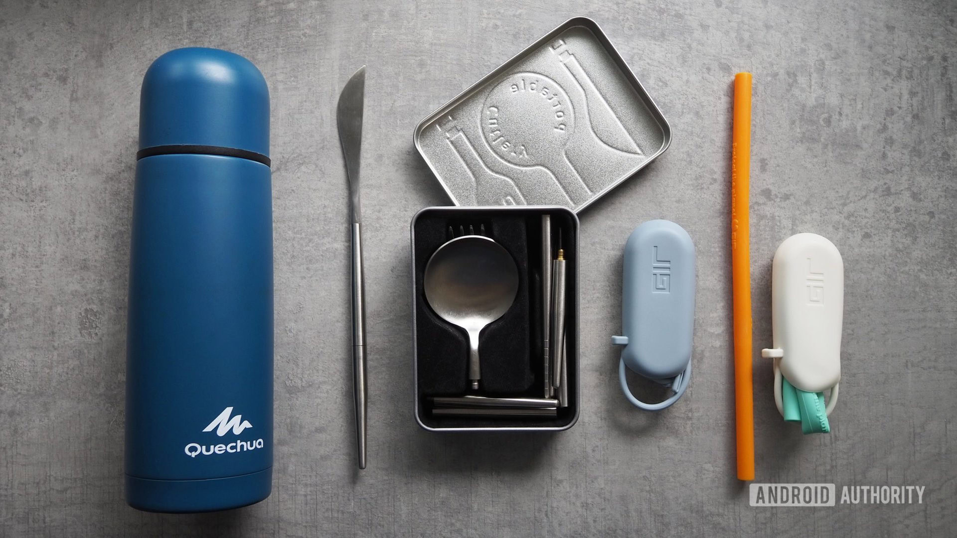 Quechua water bottle, packable cutlery set, and GIR silicone straws on a table