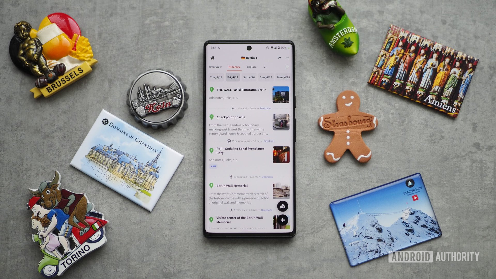 A Pixel 6 Pro on a table with travel planning app Wanderlog next to several magnet cities from Cologne, Brussels, Amsterdam and more.