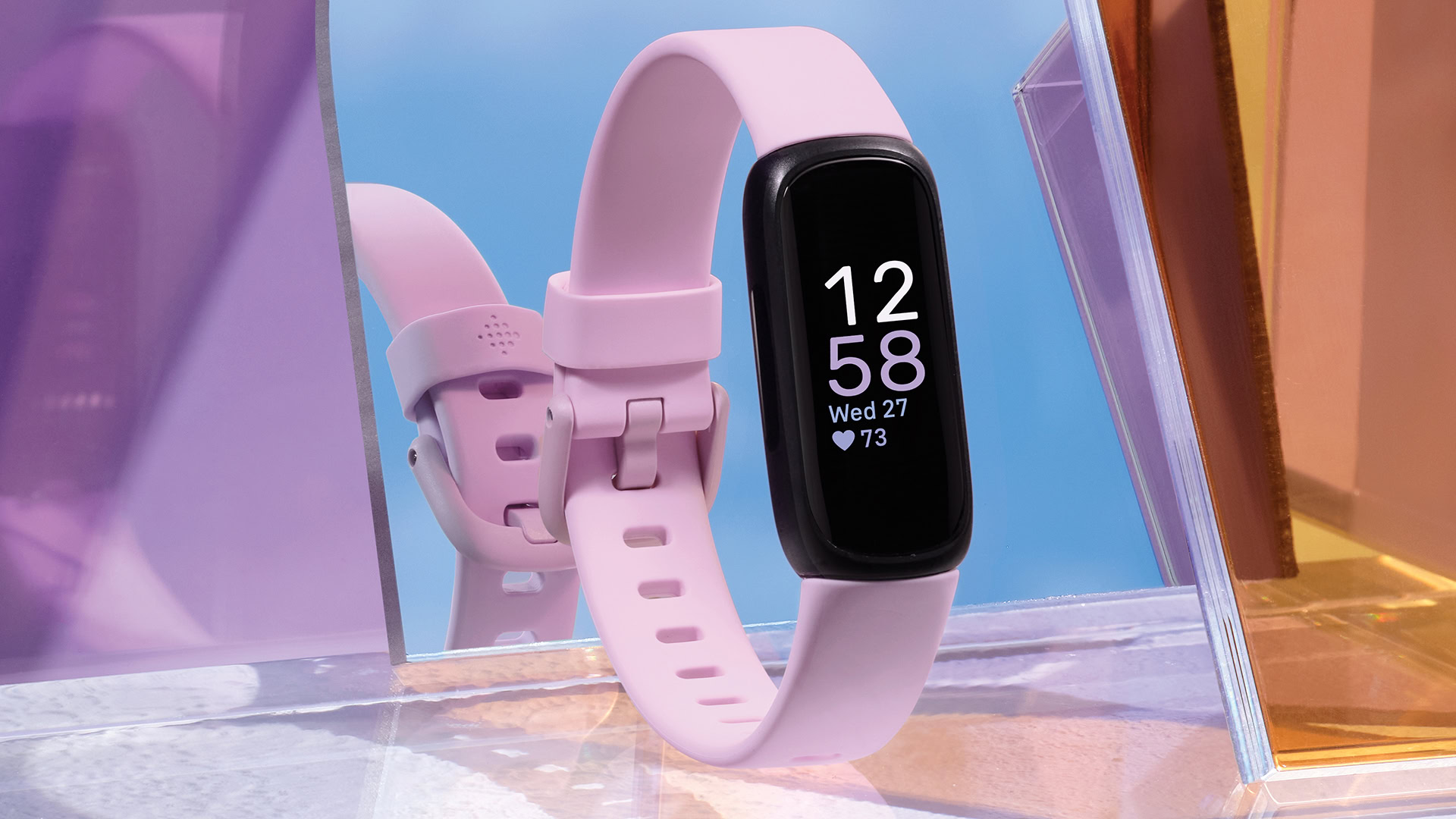 Fitbit Inspire 3 Standing on its Own Amongst Colorful Pieces of Glass