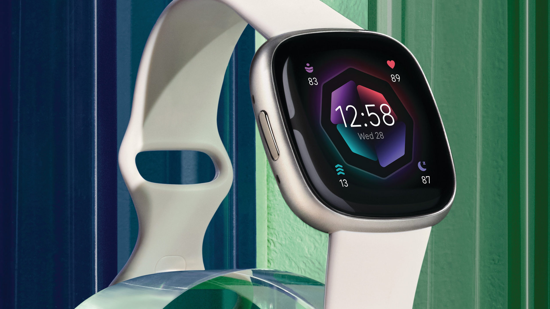A Fitbit Sense 2 in Lunar White is featured against a graphic green and blue background.