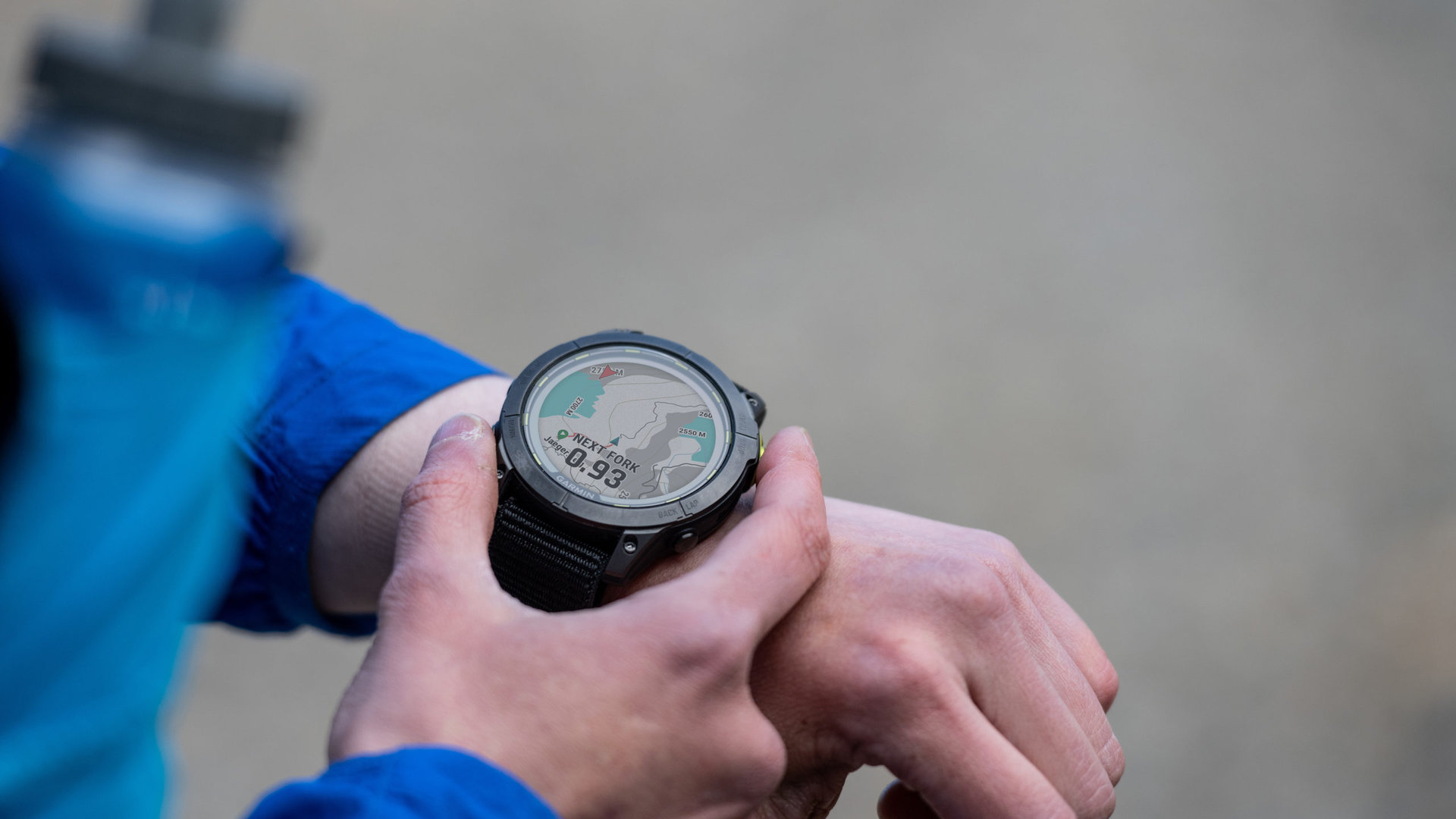 A runner browses a map on the screen of his Garmin Enduro 2.