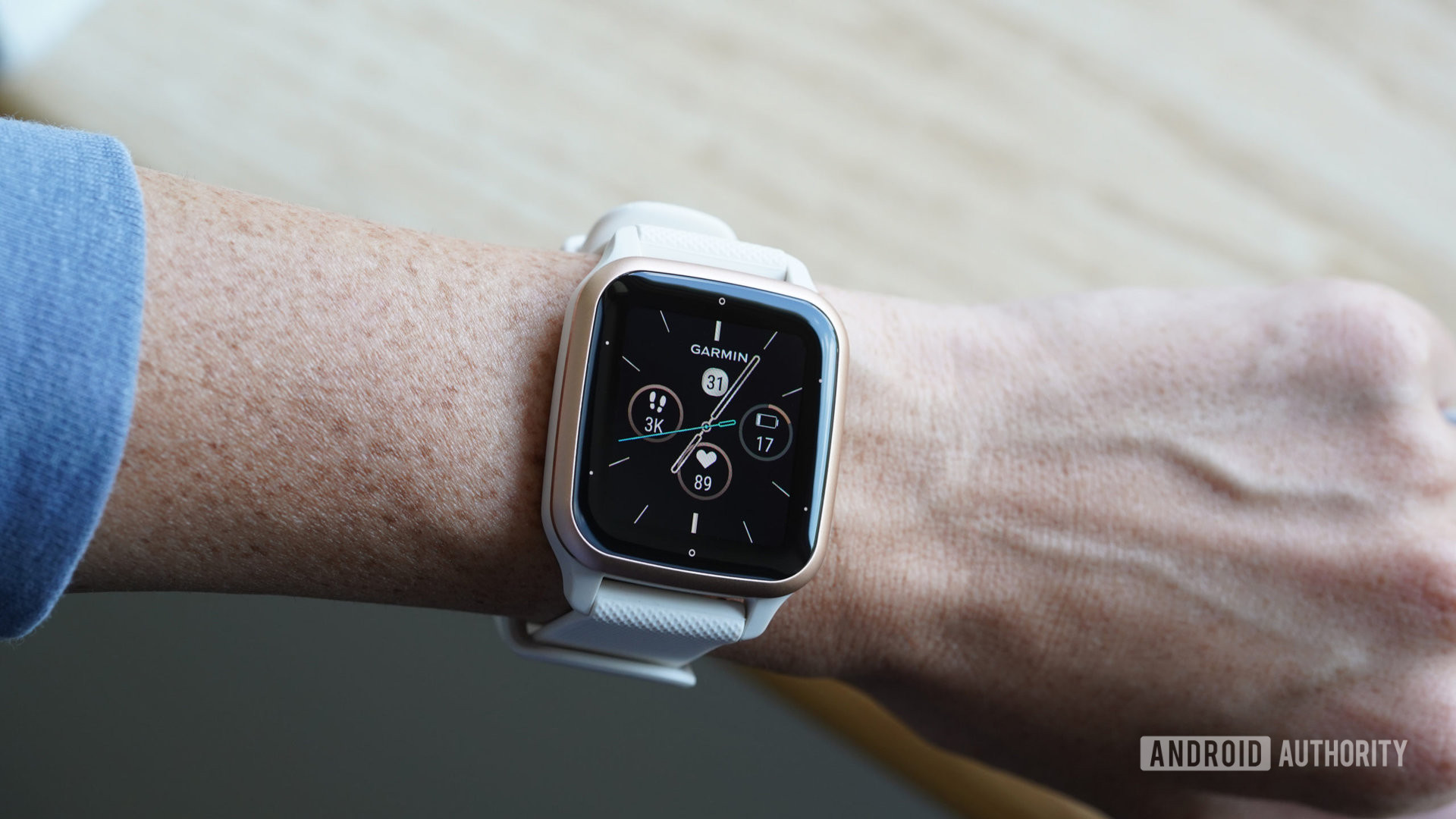 A Garmin Venu Sq 2 on a user's wrist displays a watch face.