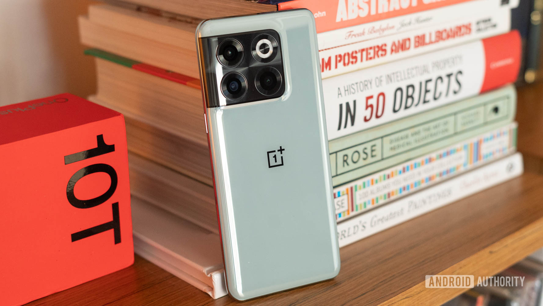 OnePlus 10T back panel next to a stack of books