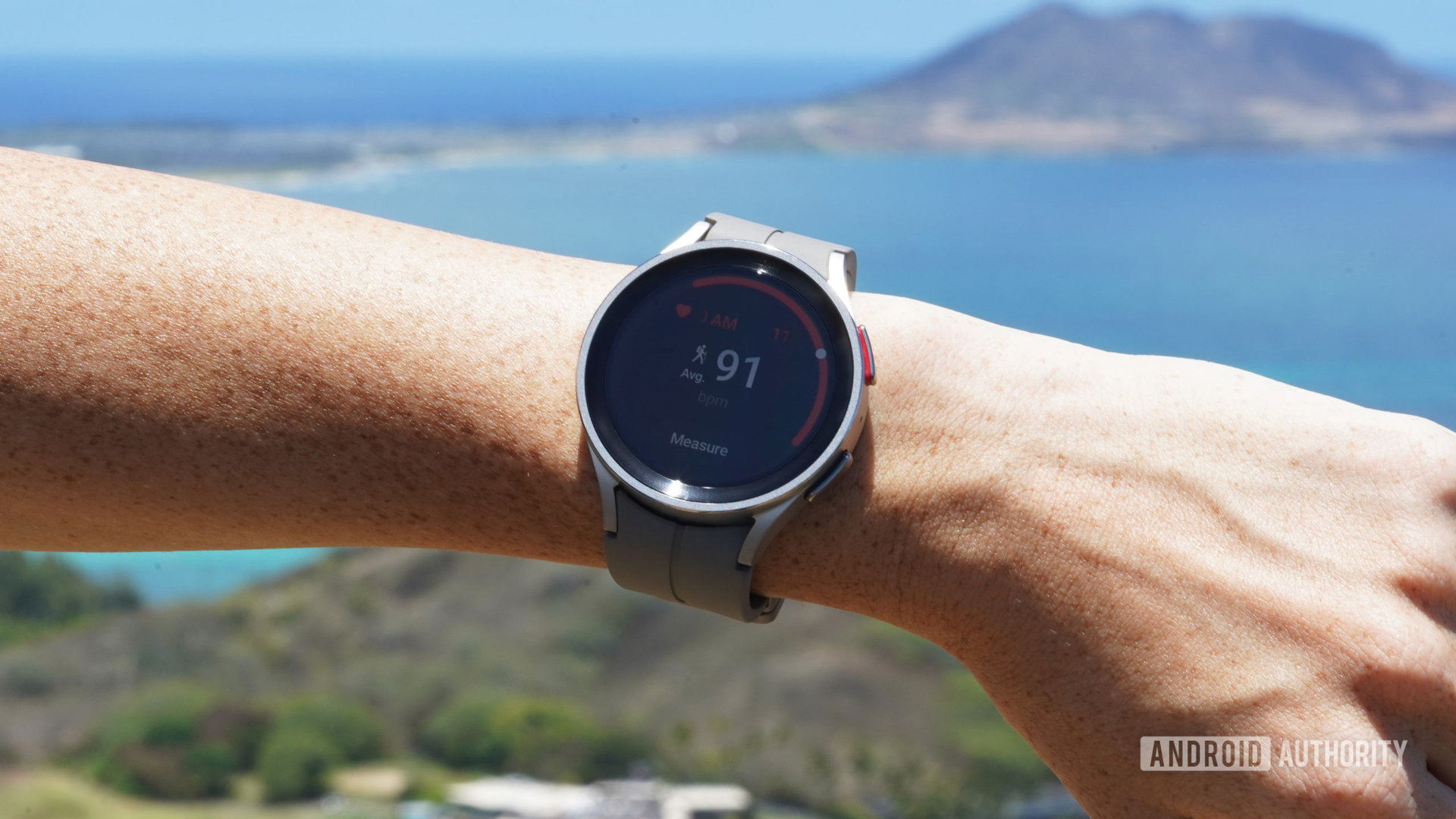 A Samsung Galaxy Watch 5 Pro displays a user's heart rate while hiking.