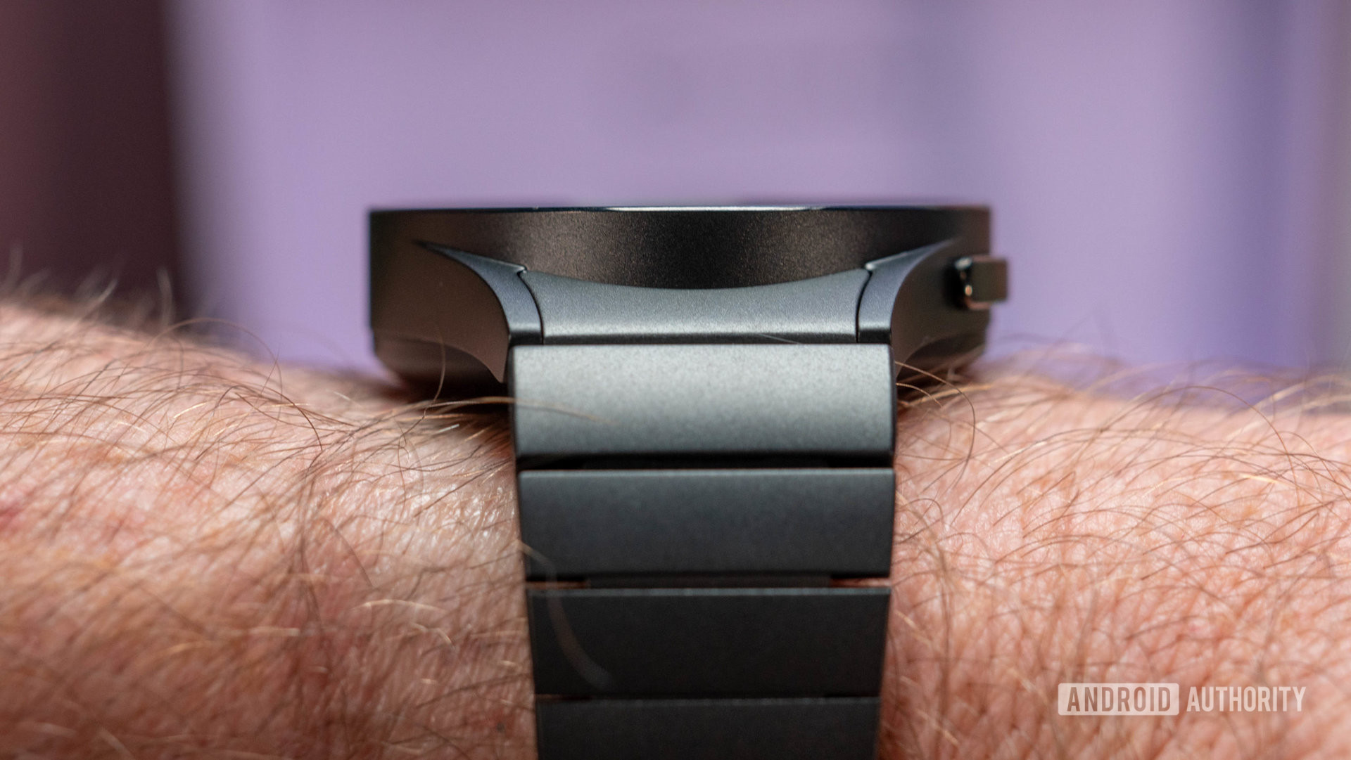 Samsung Galaxy Watch 5 Pro in black titanium color with black metal strap on wrist side profile closeup