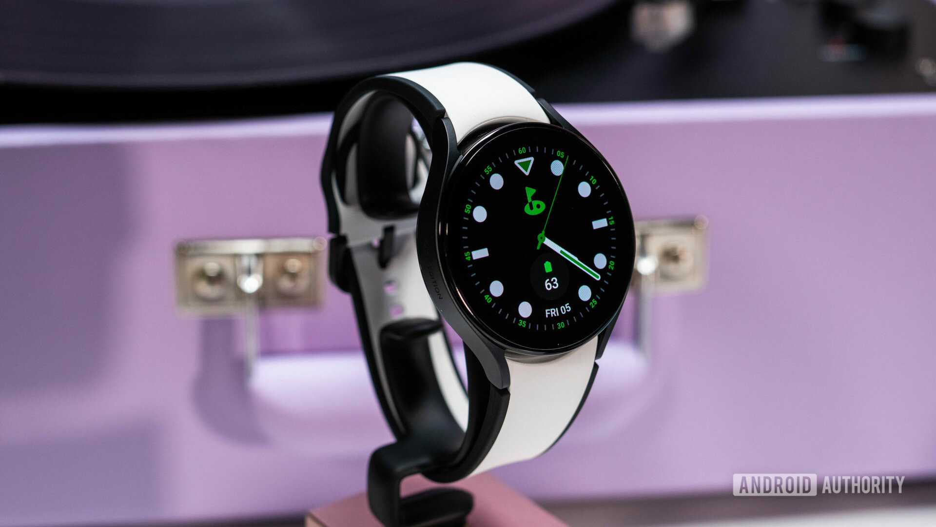 Samsung Galaxy Watch 5 with black and white watch strap on stand