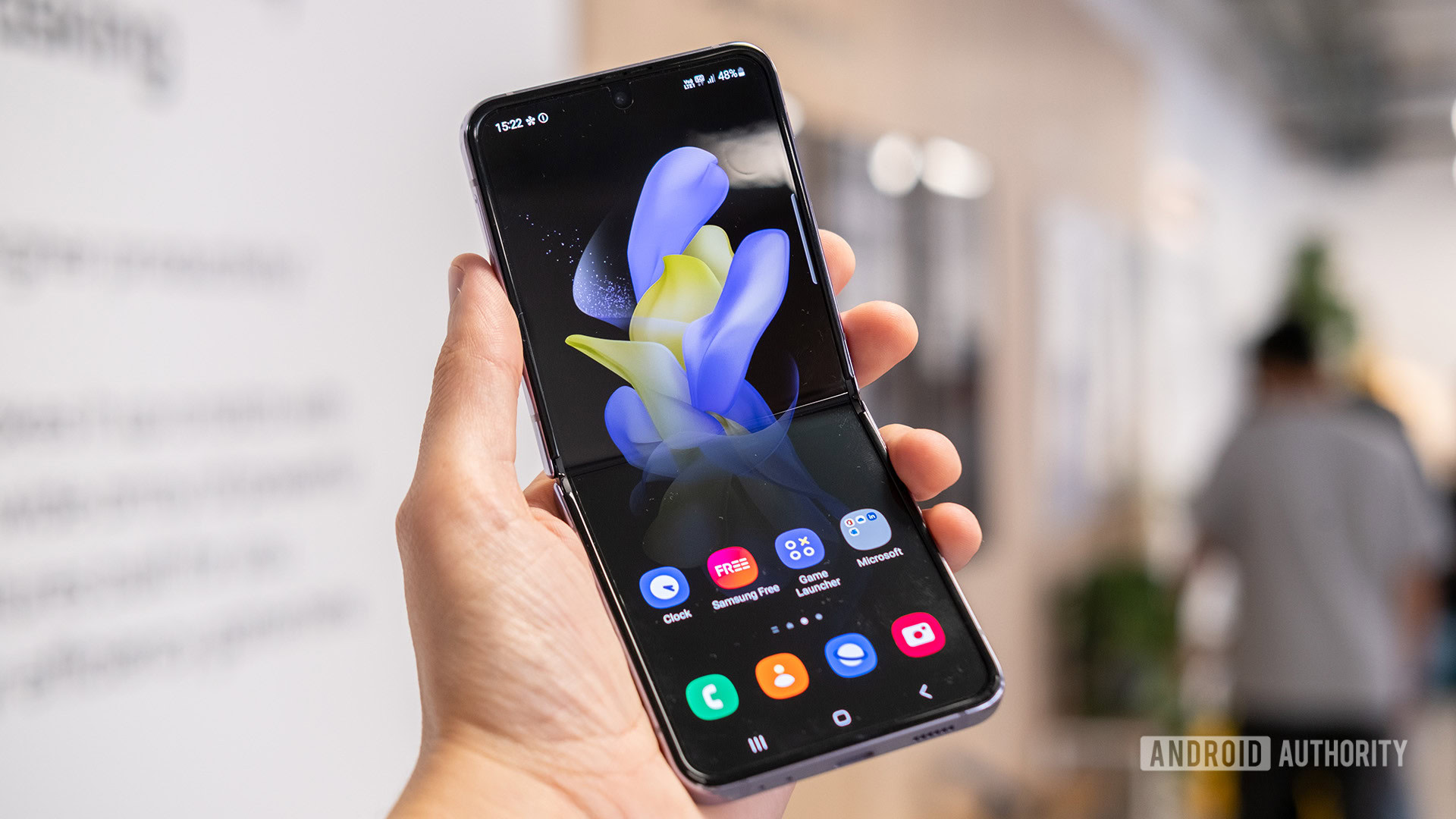 Samsung Galaxy Z Flip 4 homescreen open in hand