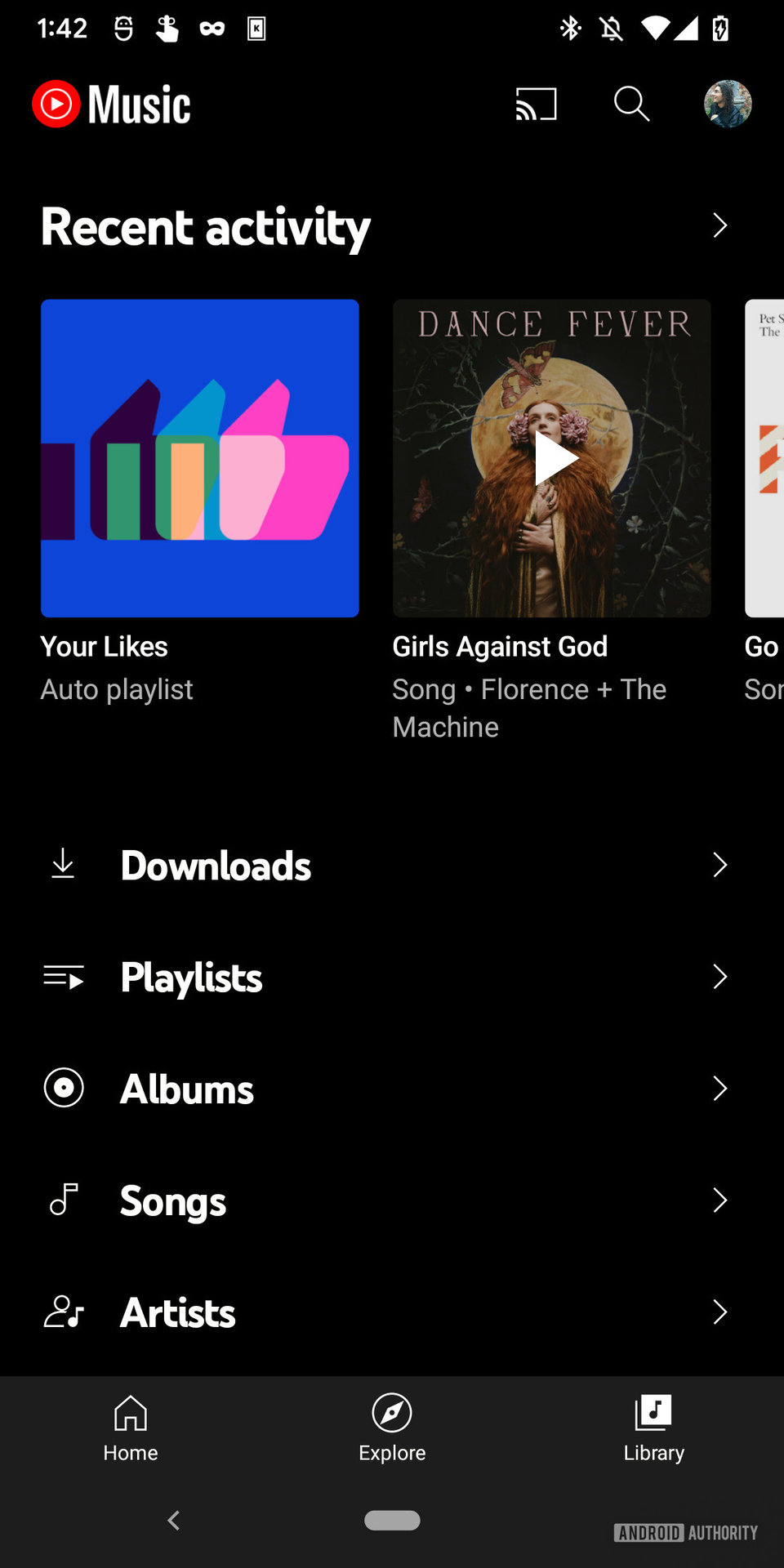 A screenshot of the YouTube Music app with a Premium subscription showing the "Library" tab with Downloads, Playlists, Albums, Songs, and Artists visible.