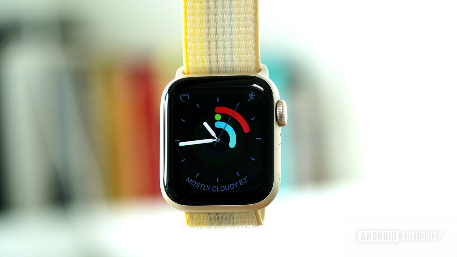 An Apple Watch SE 2 displays the Activity Analog watch face.