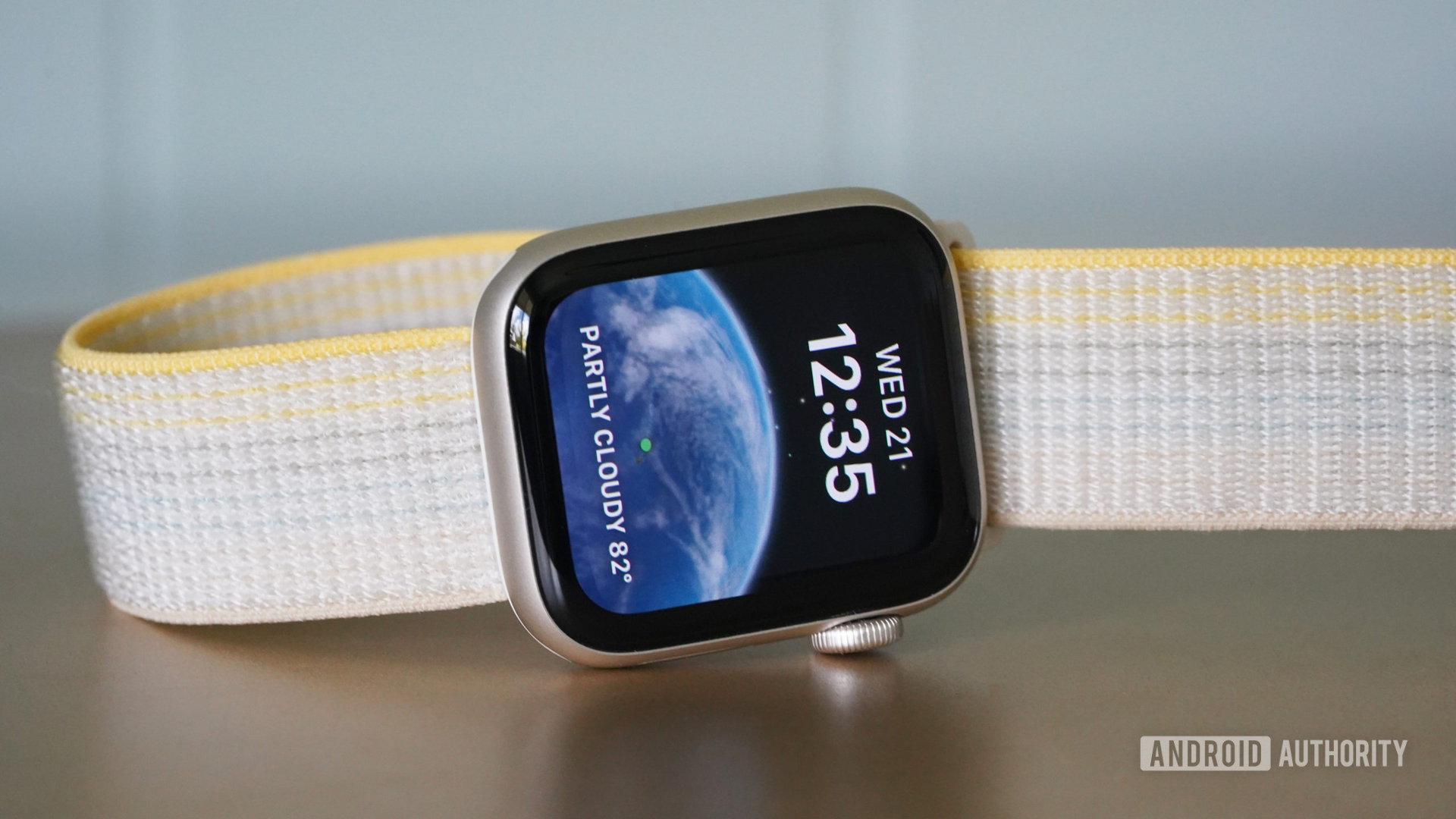 An Apple Watch SE 2 rests on its side, displaying the ASTROnomy watch face.