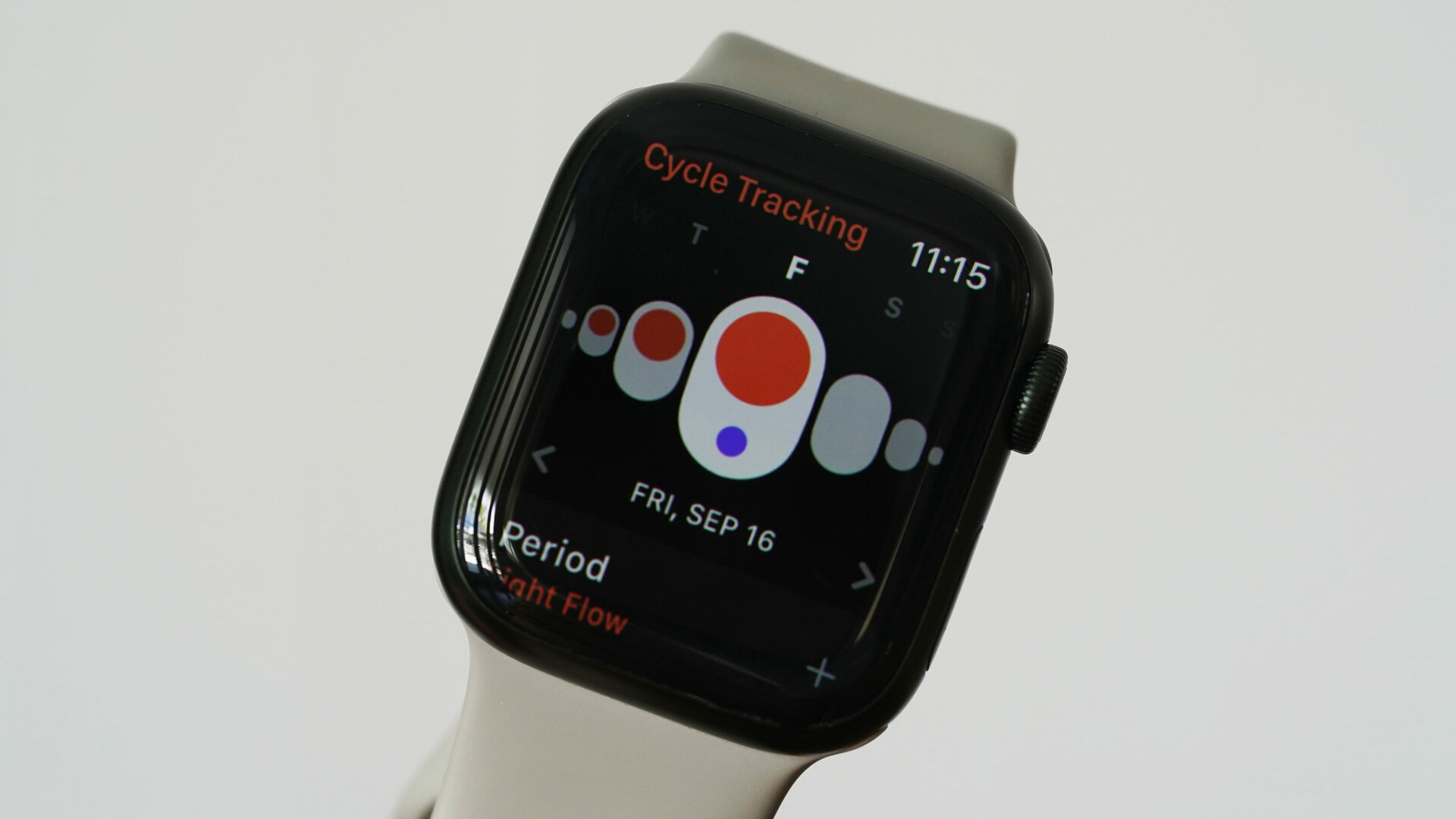 An Apple Watch Series 7 displays a user's logged period in the Cycle Tracking app.