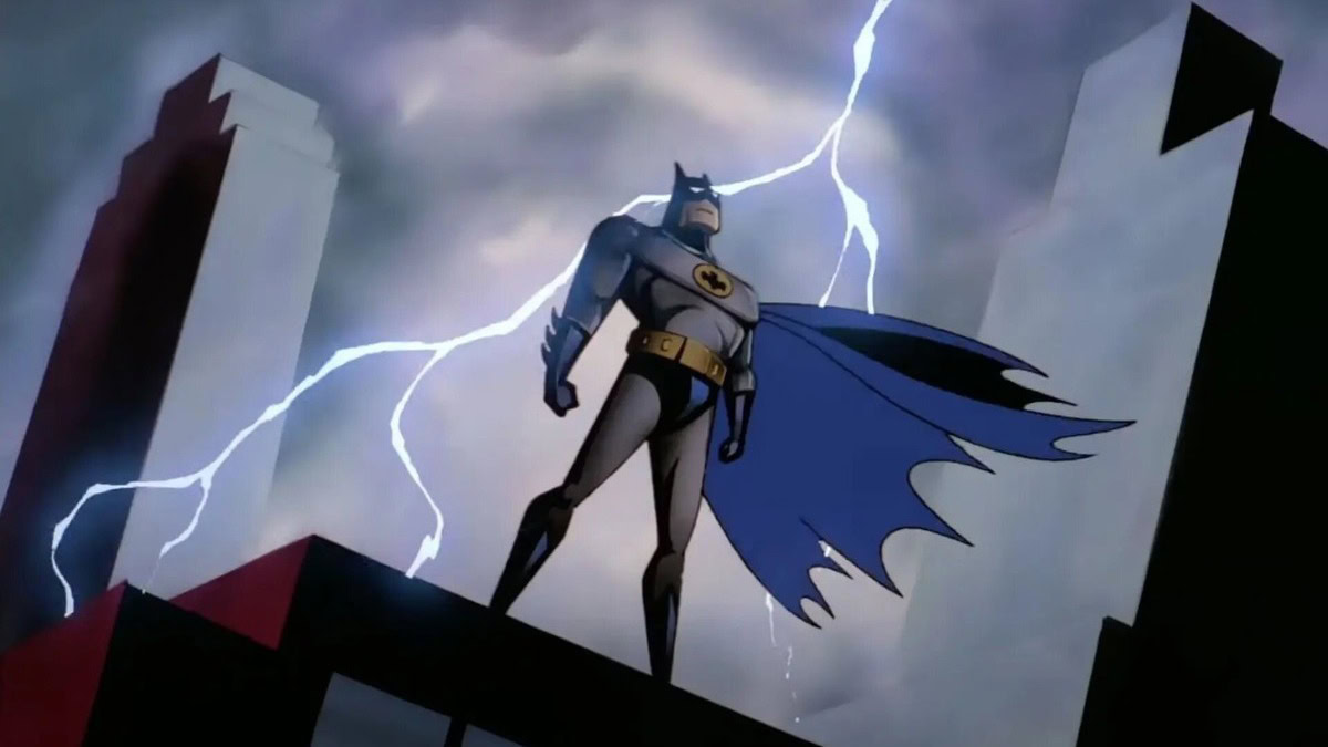 Batman standing on a building lighting