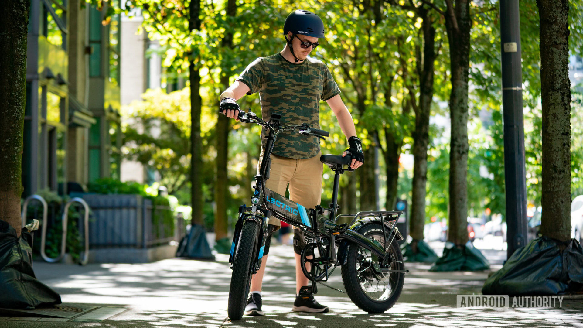 Adam standing with XP 2.0 electric bike under trees