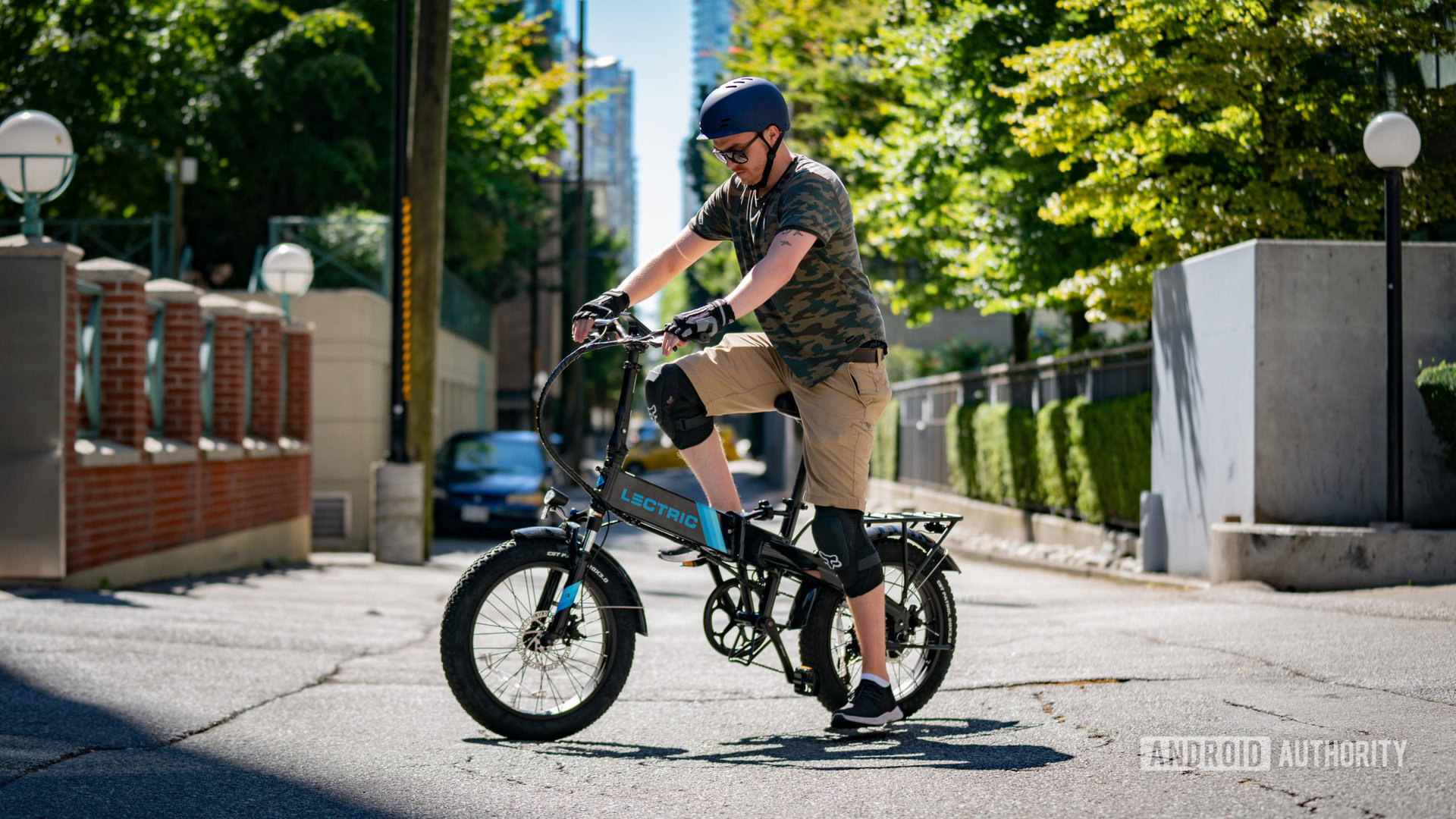 Adam mounting an electric bike in driveway