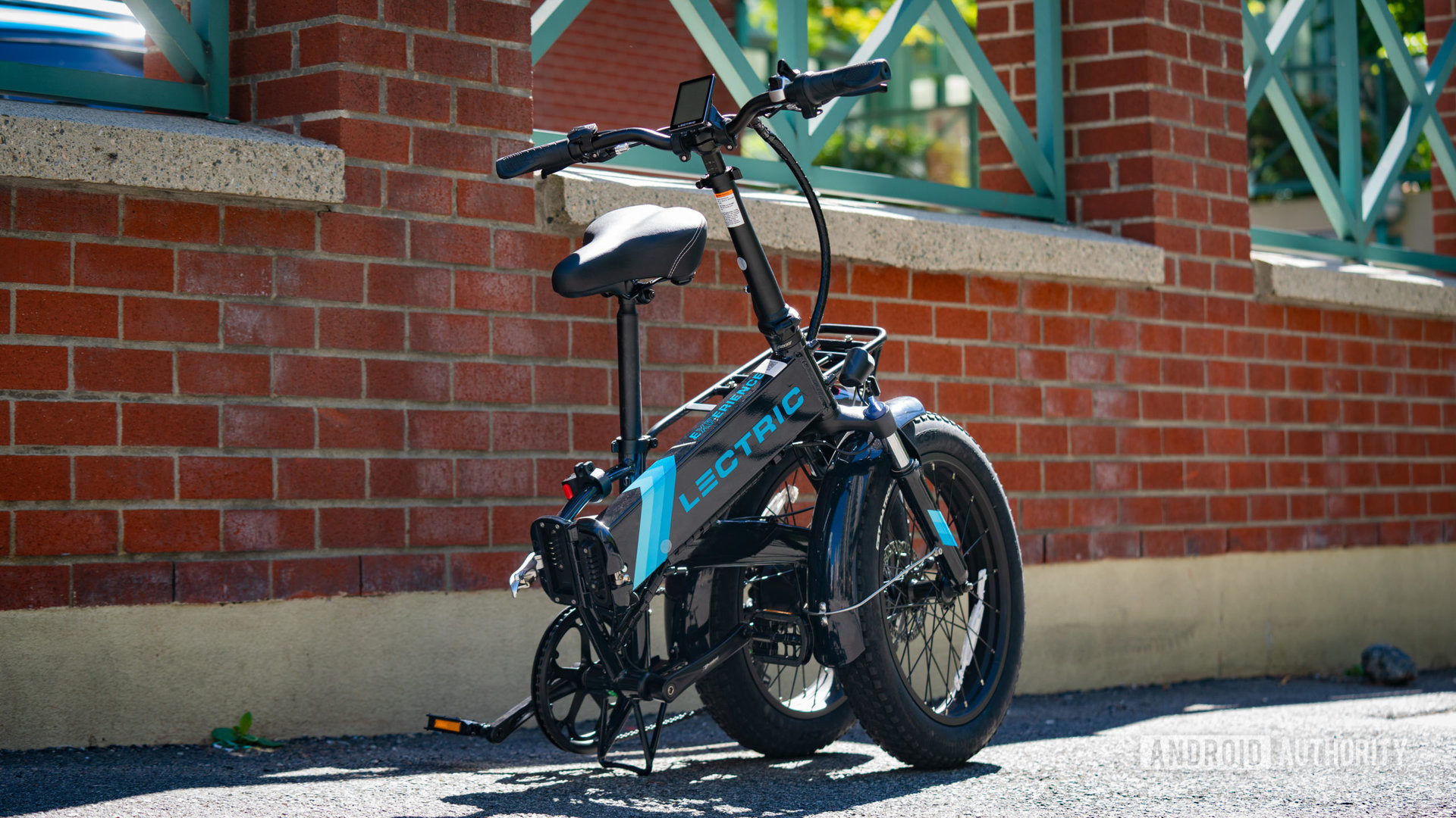 Lectric XP. 2.0 bike folded in front of brick wall