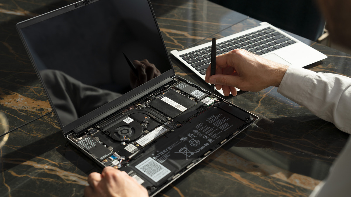 person fixing laptop