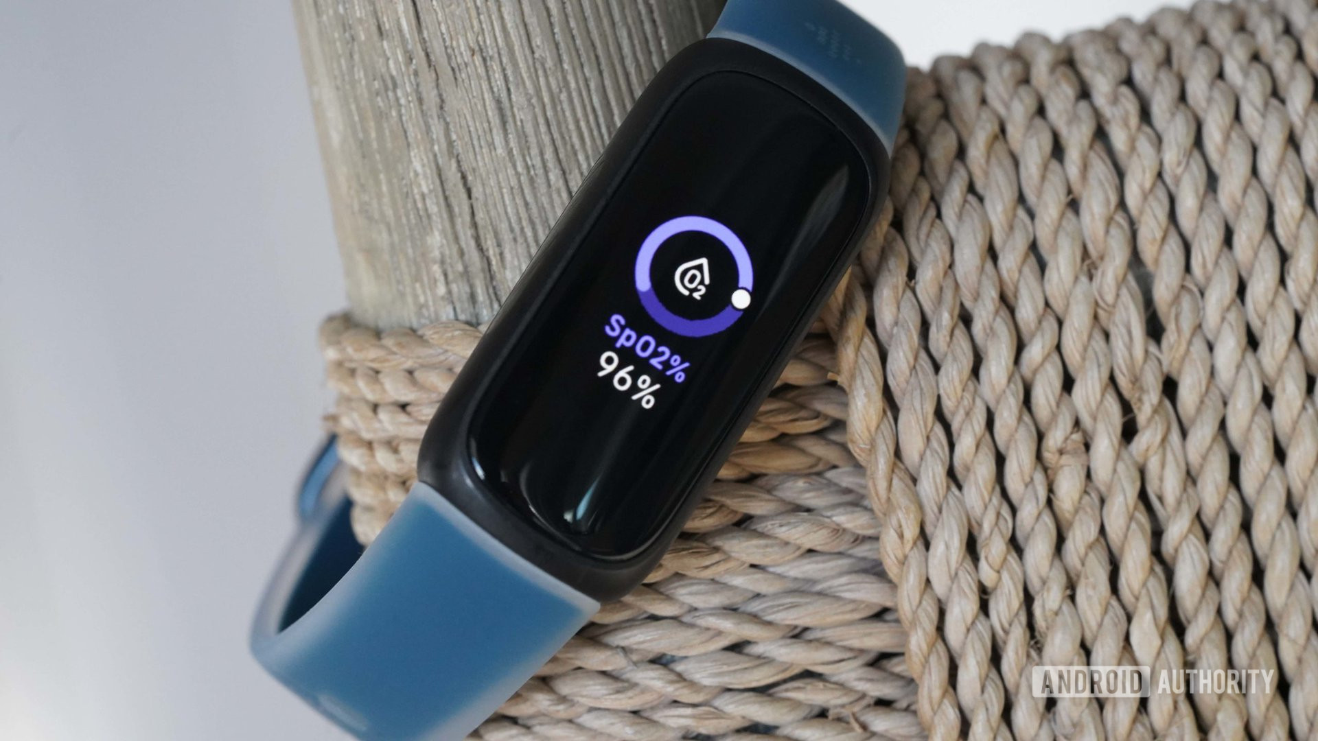A Fitbit Inspire 3 displays a user's SpO2 level.