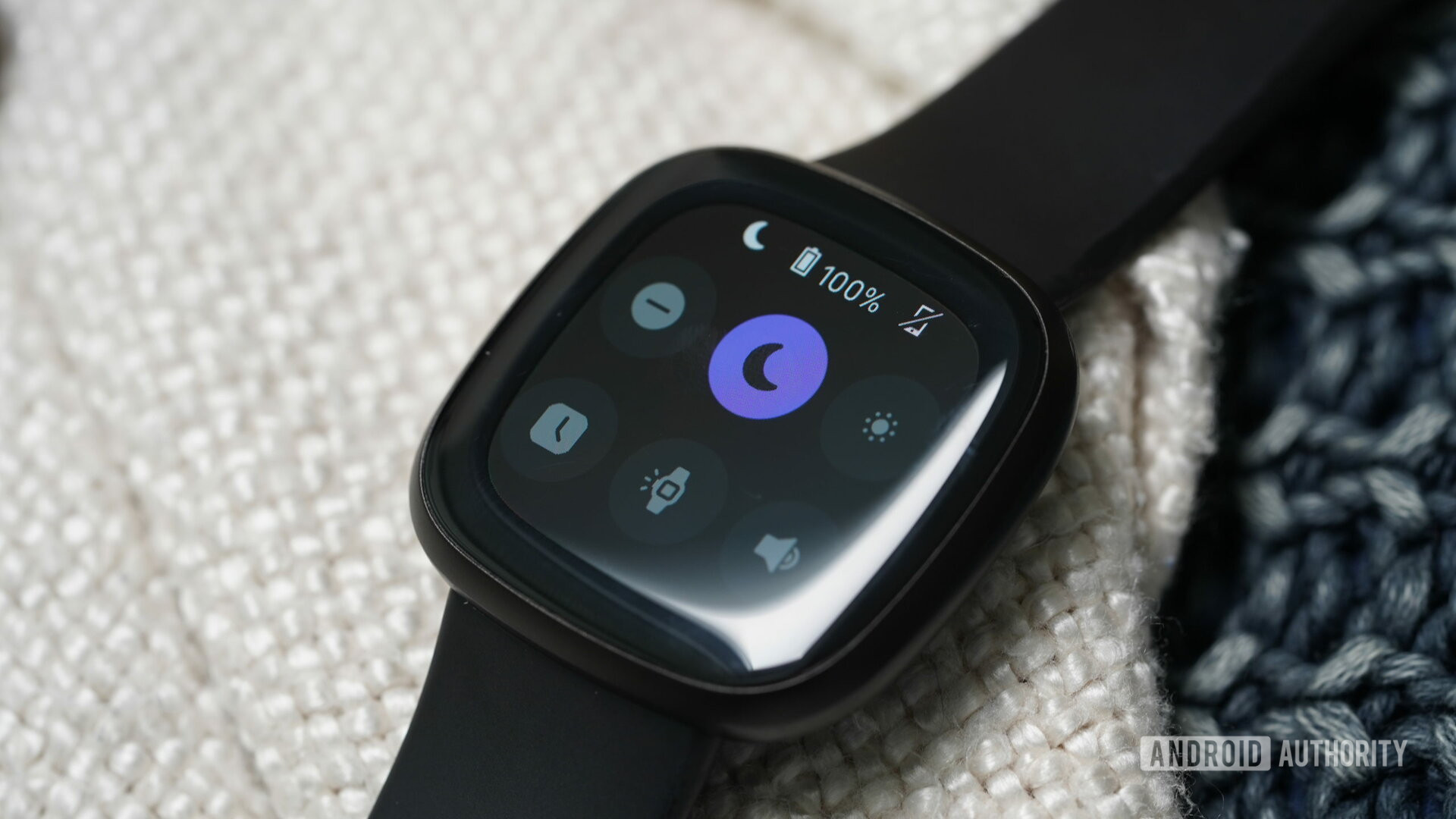 A Fitbit Versa 3 displays the quick panel menu with Do Not Disturb enabled.