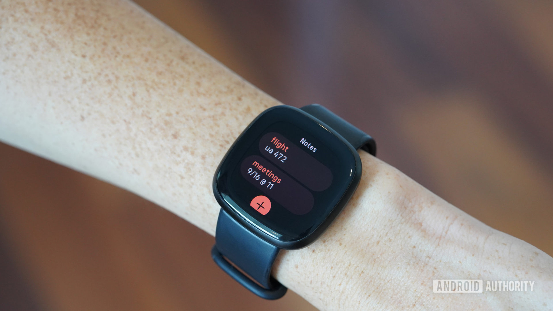 A Fitbit Versa 3 displays a user's list of notes in the app Notes.