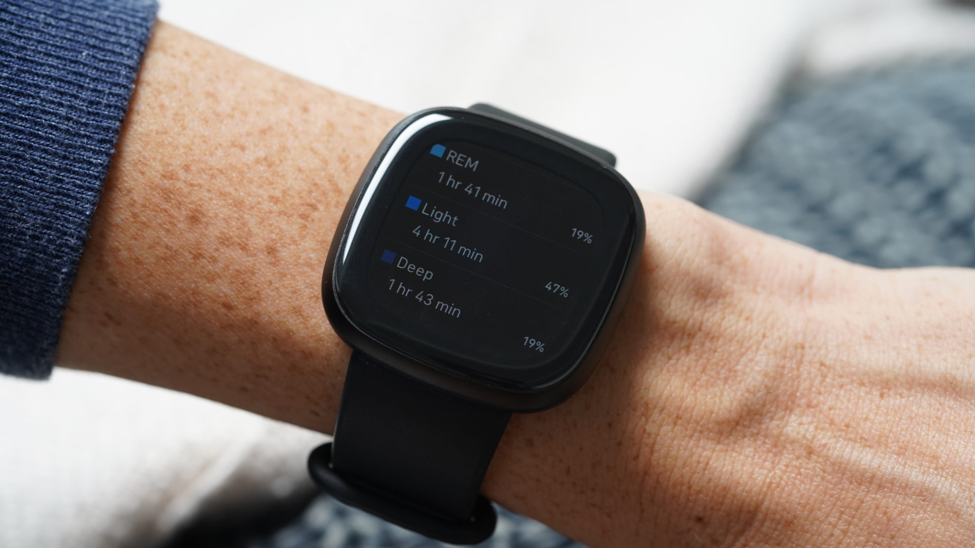 A user reviews their sleep stages on a Fitbit Versa 3.