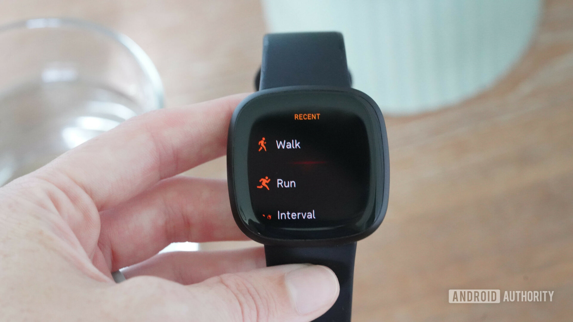 A user reviews activity options on their Fitbit Versa 3.