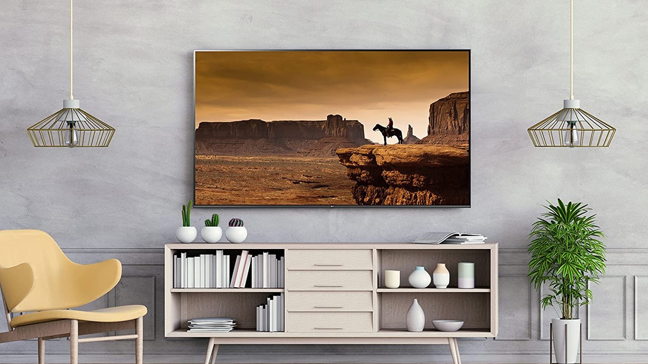Product image of the UQ75 series 86-inch LG LED 4K UHD Smart webOS TV from the LG series in a Midcentury Modern style room.