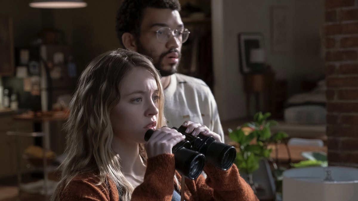 Sydney Sweeney and Justice Smith stand at a window with binoculars in The Voyeurs - best prime video original movies