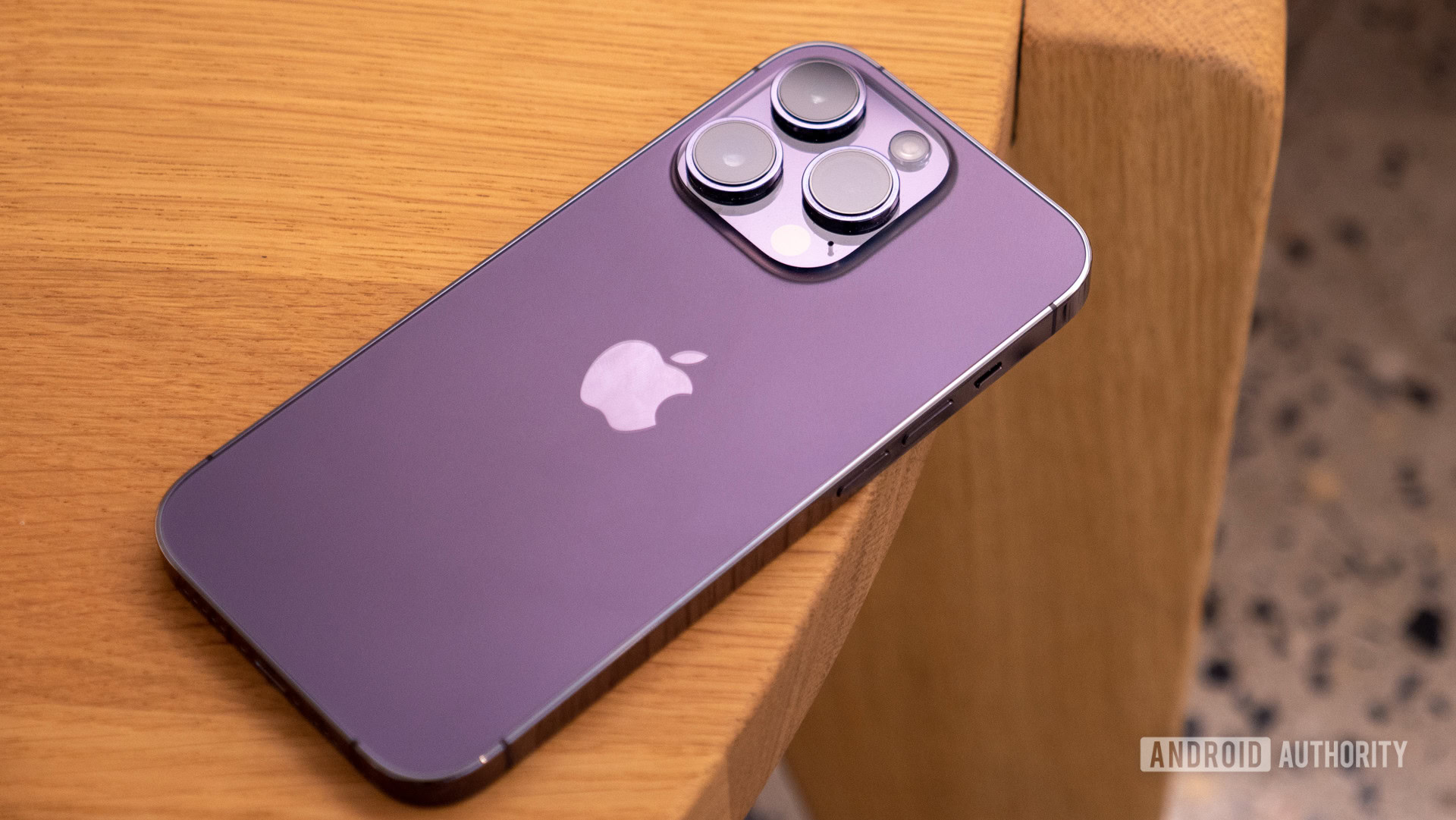 Apple iPhone 14 Pro deep purple laying face down on a table showing the rear and camera module