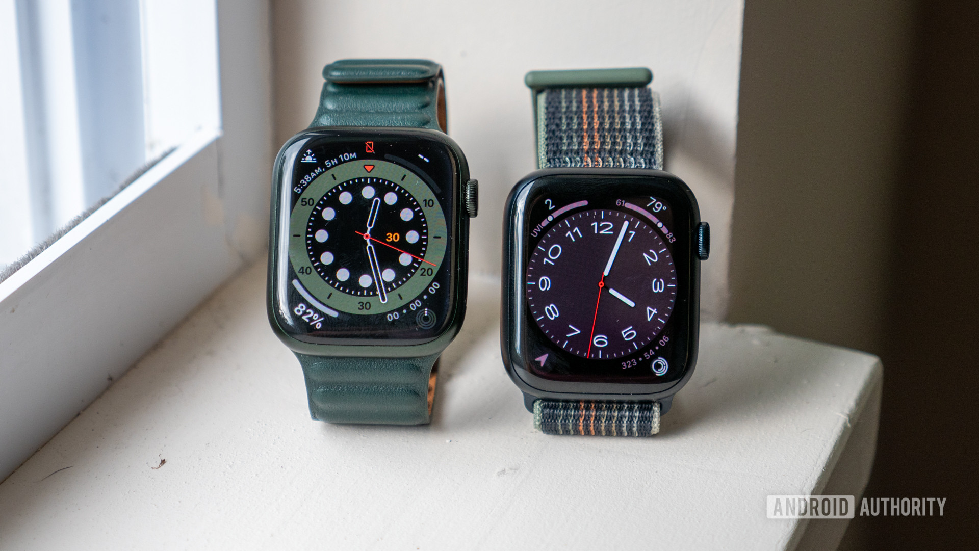 The Apple Watch Series 8 alongside the Apple Watch Series 7 on a windowsill, showing both watch faces.