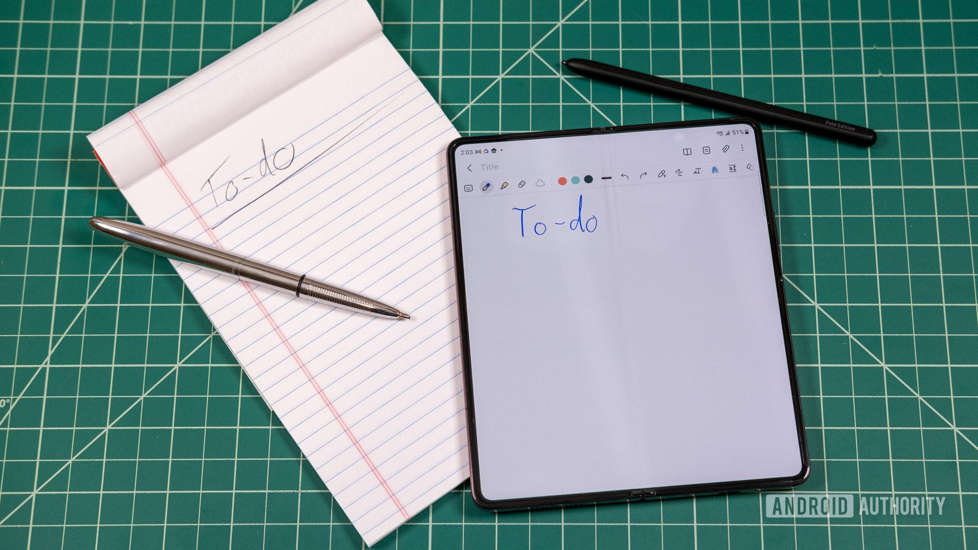 Samsung Galaxy Z Fold 4 with S Pen next to a to-do notebook with a pen