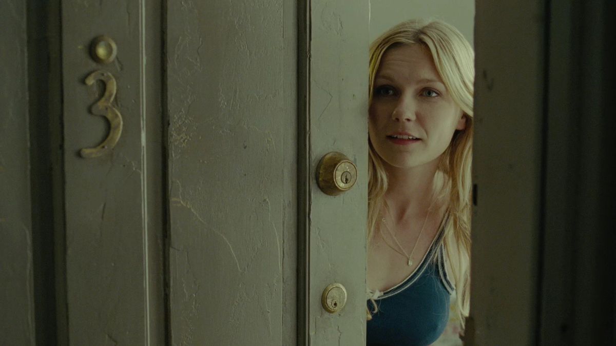 Kirsten Dunst answers the door in All Good Things - true crime drama
