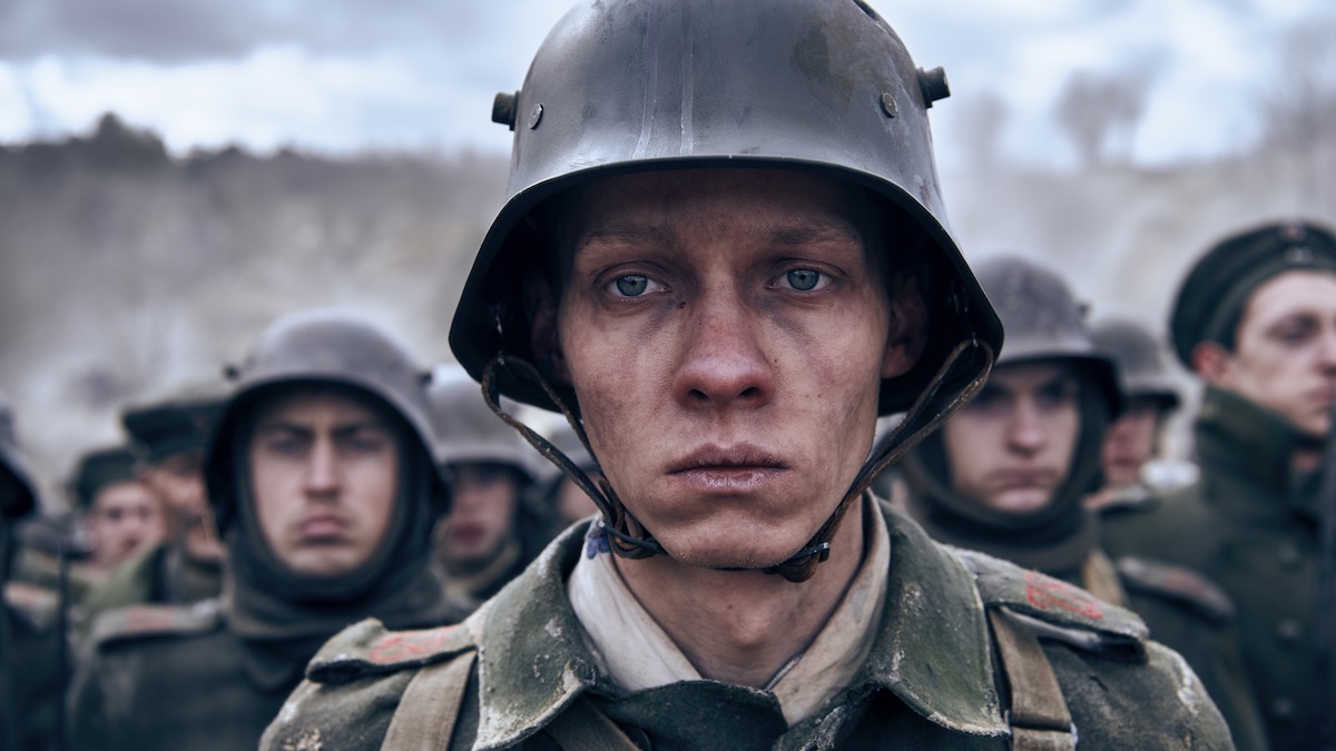 A close-up of a young soldier's face in All Quiet on the Western Front - war movies on Netflix