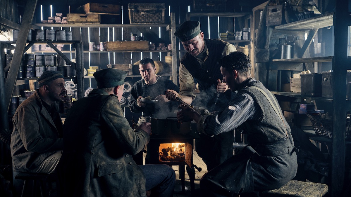 A group of soldiers eat together over a small stove in All Quiet on the Western Front - best new streaming movies