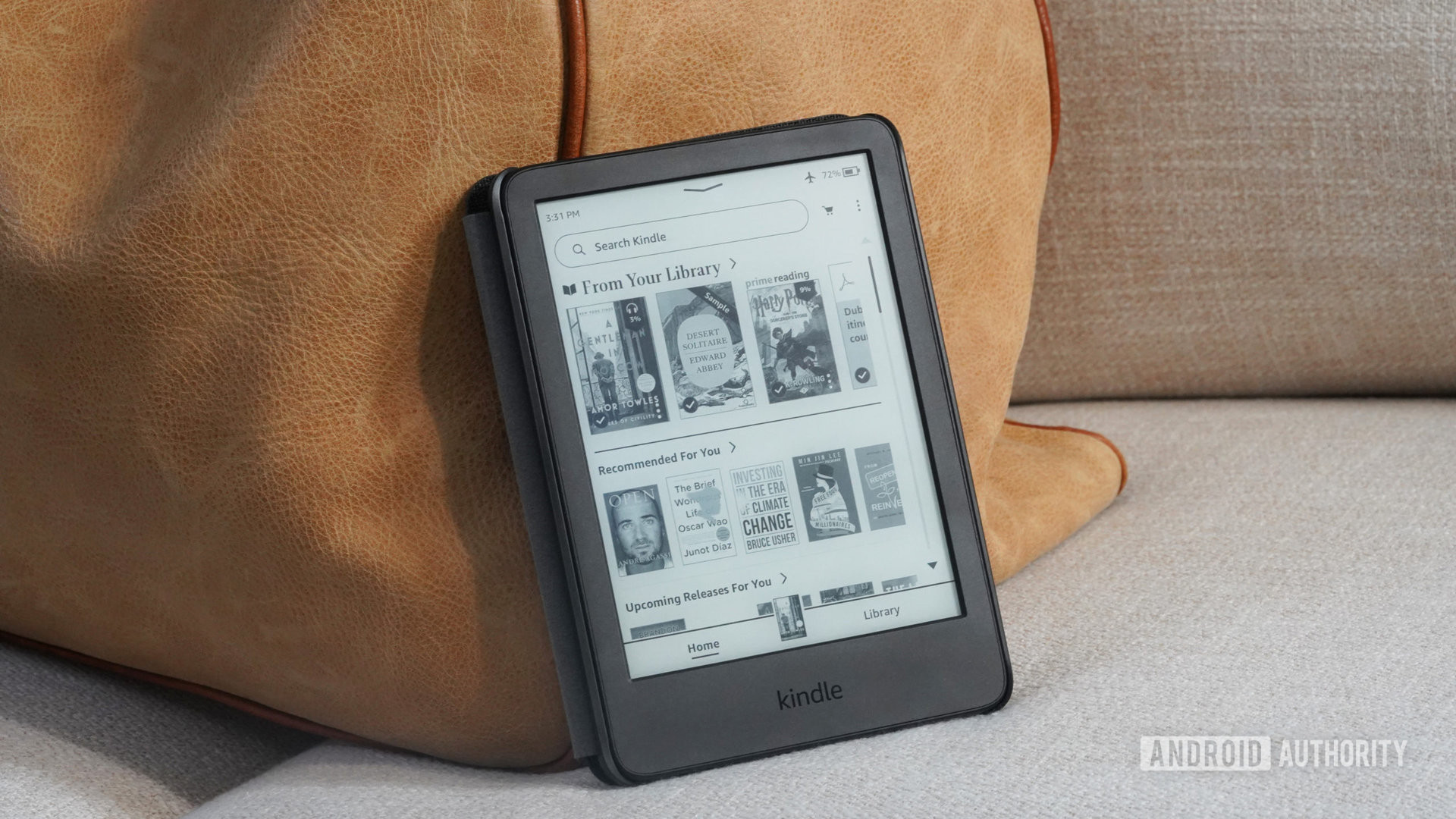 A user's Amazon Kindle 2022 rests against a piece of carry on luggage.