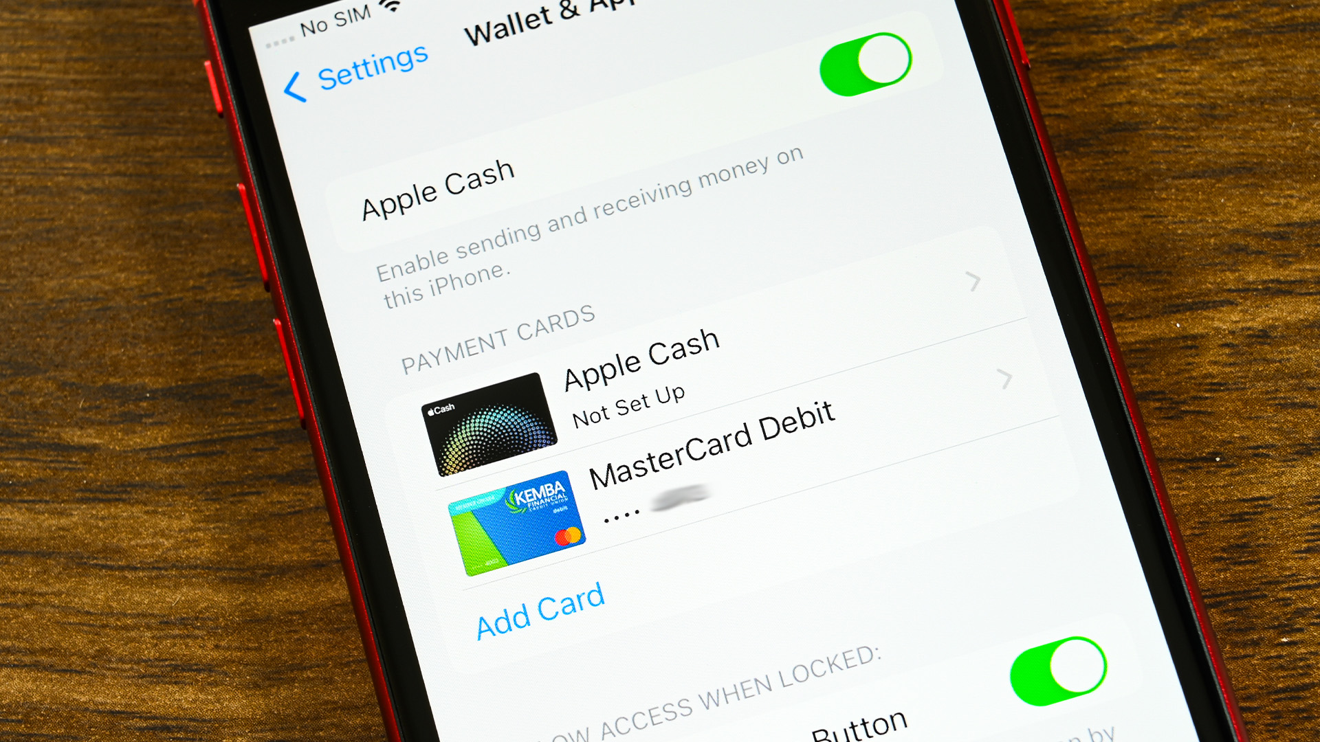 A smartphone showing the Apple Pay app's settings page with various payment methods and the option to add a card.
