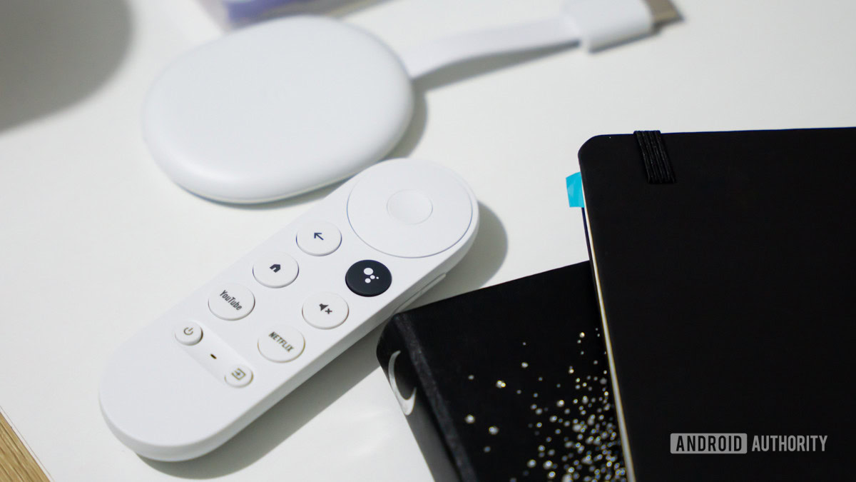 Chromecast with Google TV HD next to remote 2