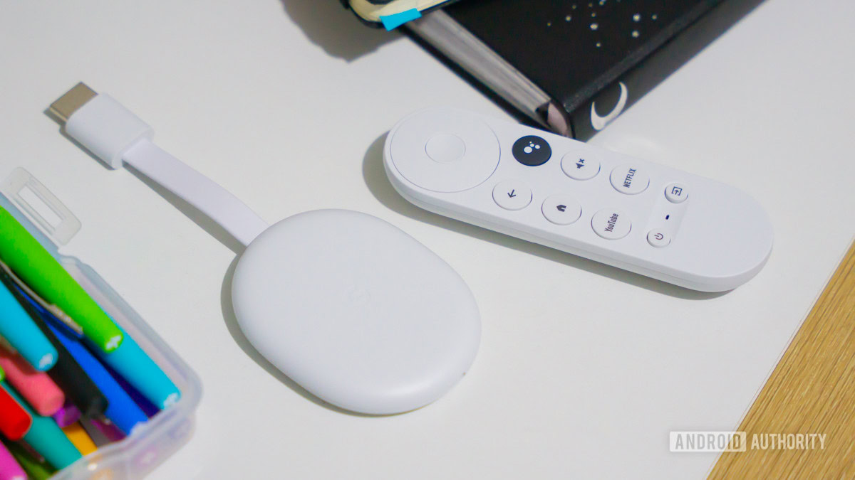 Chromecast with Google TV HD next to remote 3