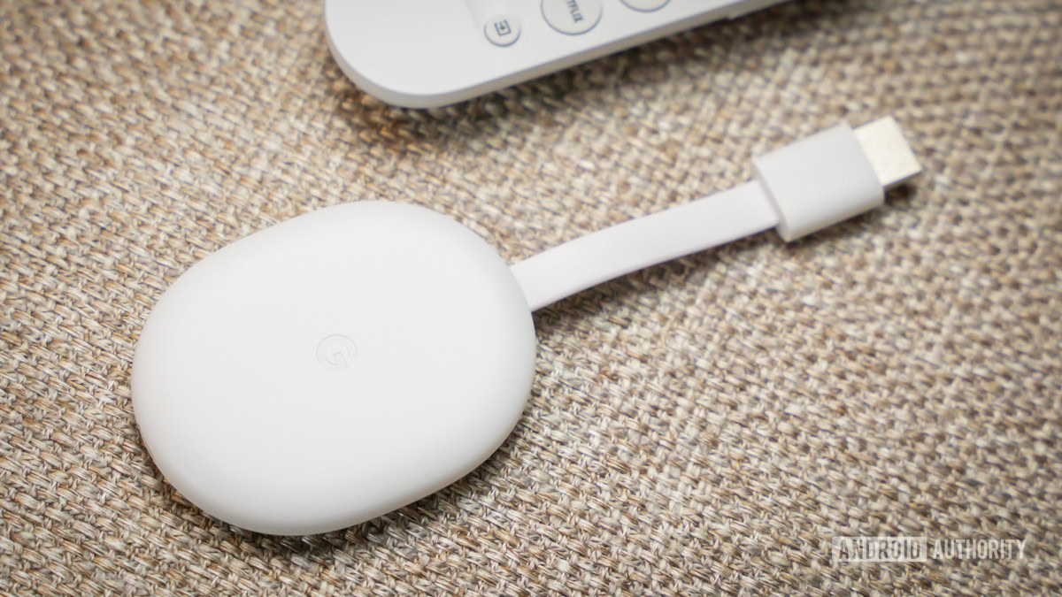 Chromecast with Google TV HD next to the remote 5