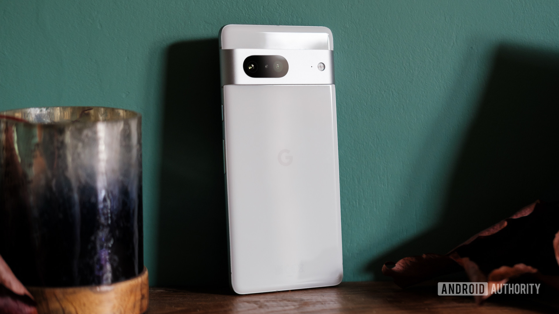Close up rear view of Google Pixel 7 on green wall