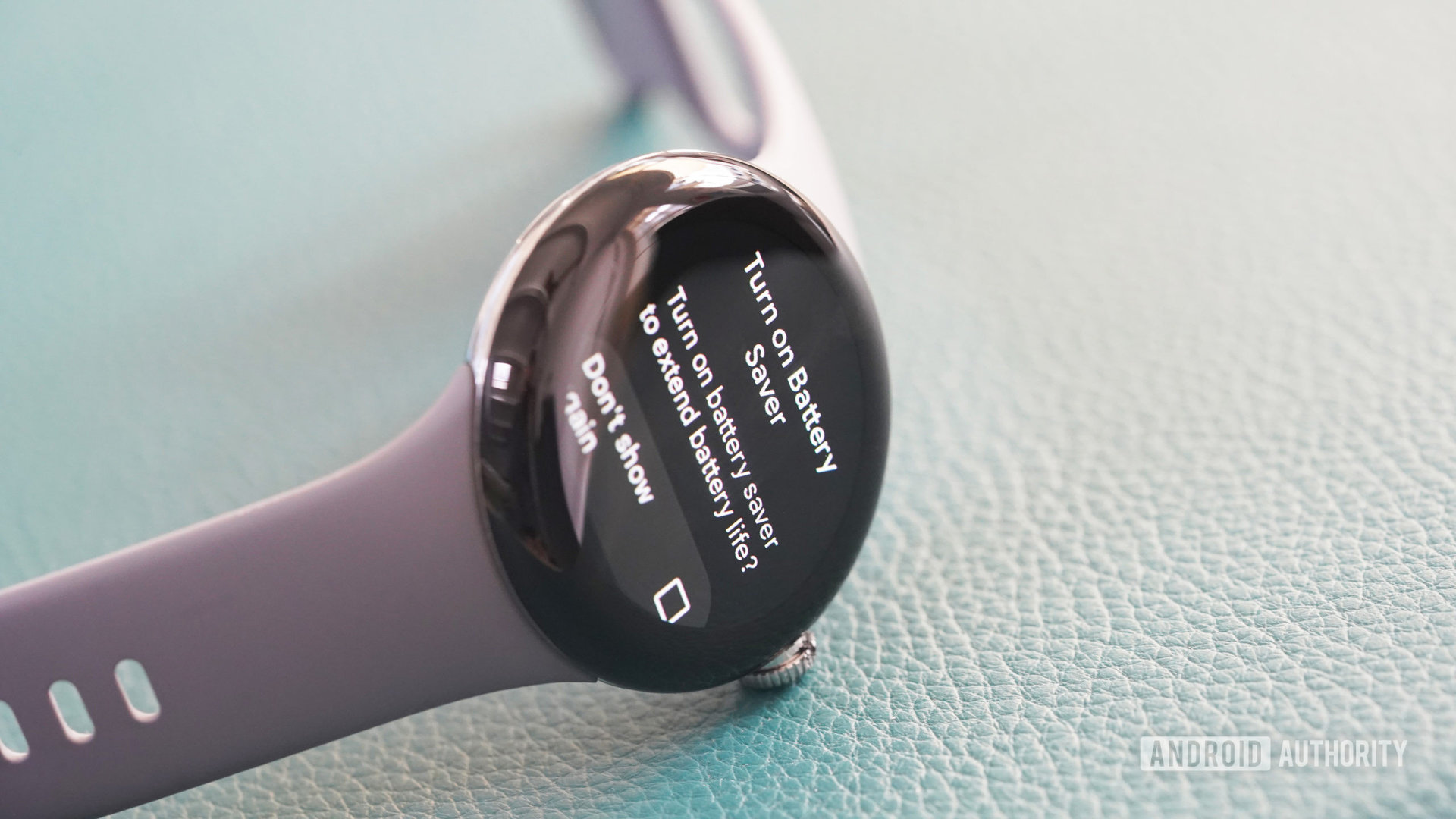 A Google Pixel Watch rests on its side display the Battery Saver confirmation screen.