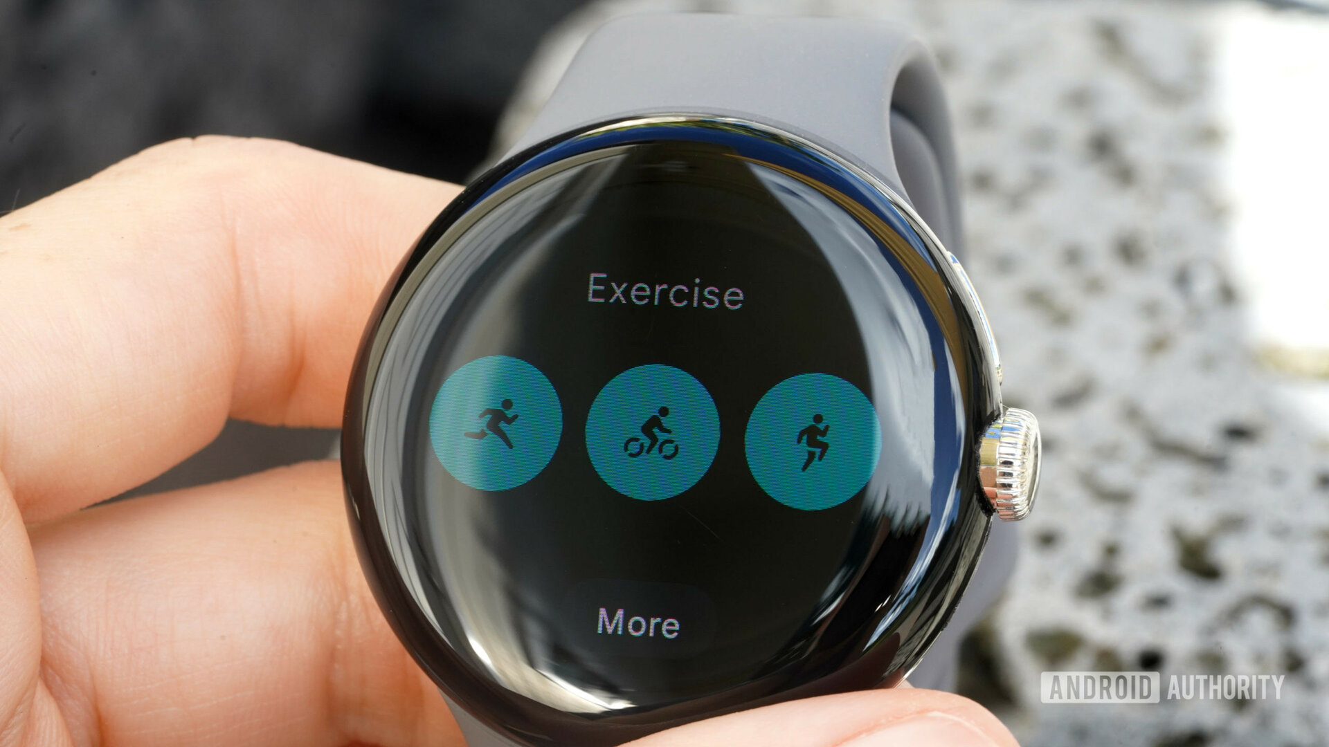 A Google Pixel Watch in a user's hand displays three exercises modes.