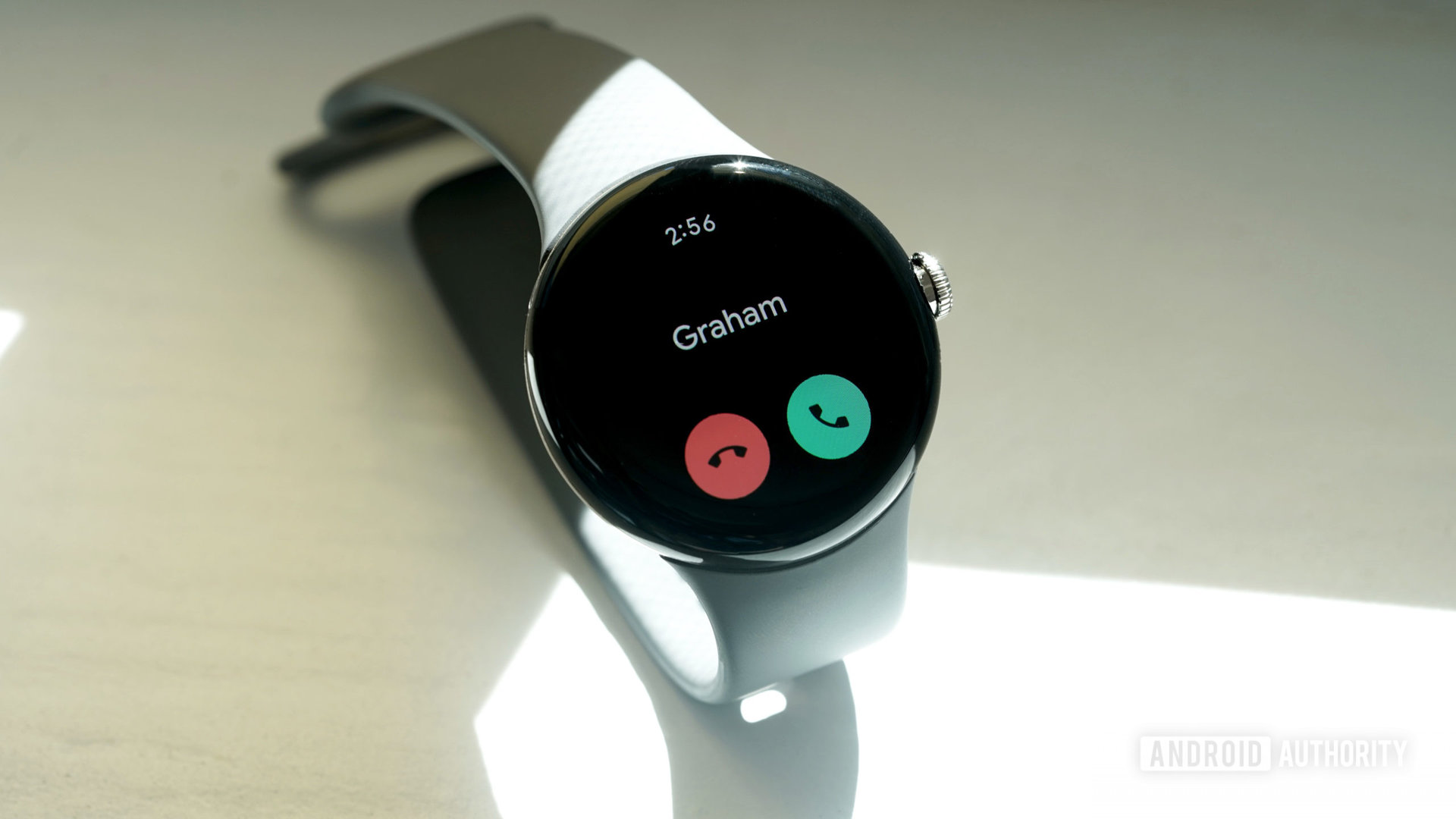 A Google Pixel Watch displays an incoming call.