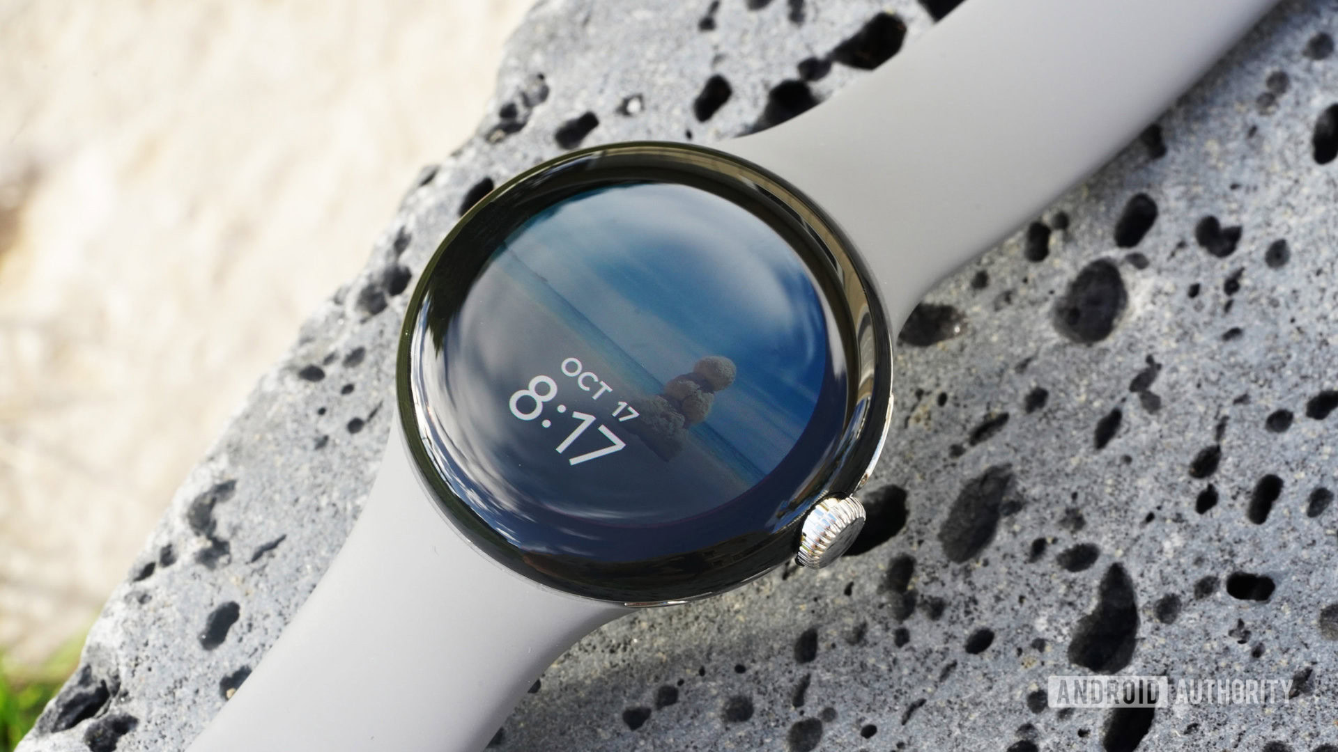 The Photo watch face on a Google Pixel Watch draws attention to the device's large bezel.