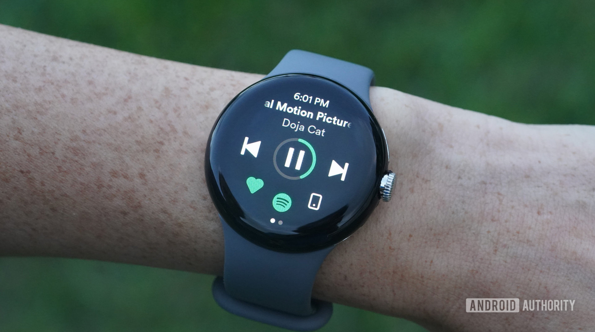 A Google Pixel Watch displays a user's Spotify app.
